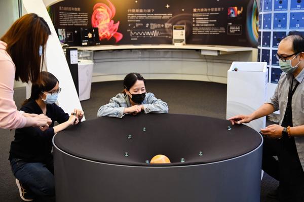 An exhibition using marbles to simulate planetary orbits.