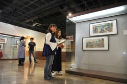 The 46 works in the exhibition depict people engaged in such activities as viewing flowers and watching a performance.