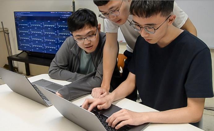 
Team members (left to right) Huang, Chang, and Wang preparing for the competition.