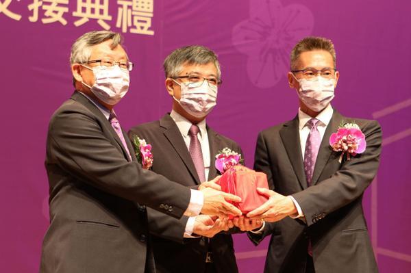Kao (right) receiving the official school seal from Hocheng (left), with Lio (center) as the facilitator.