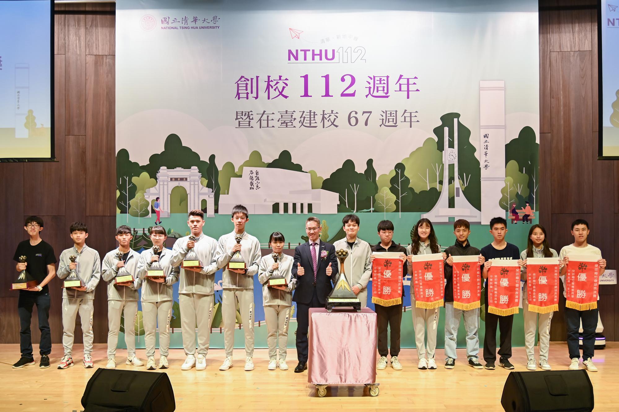Representatives of the winning teams at this year's Meizhu Tournament presenting the trophy to NTHU.