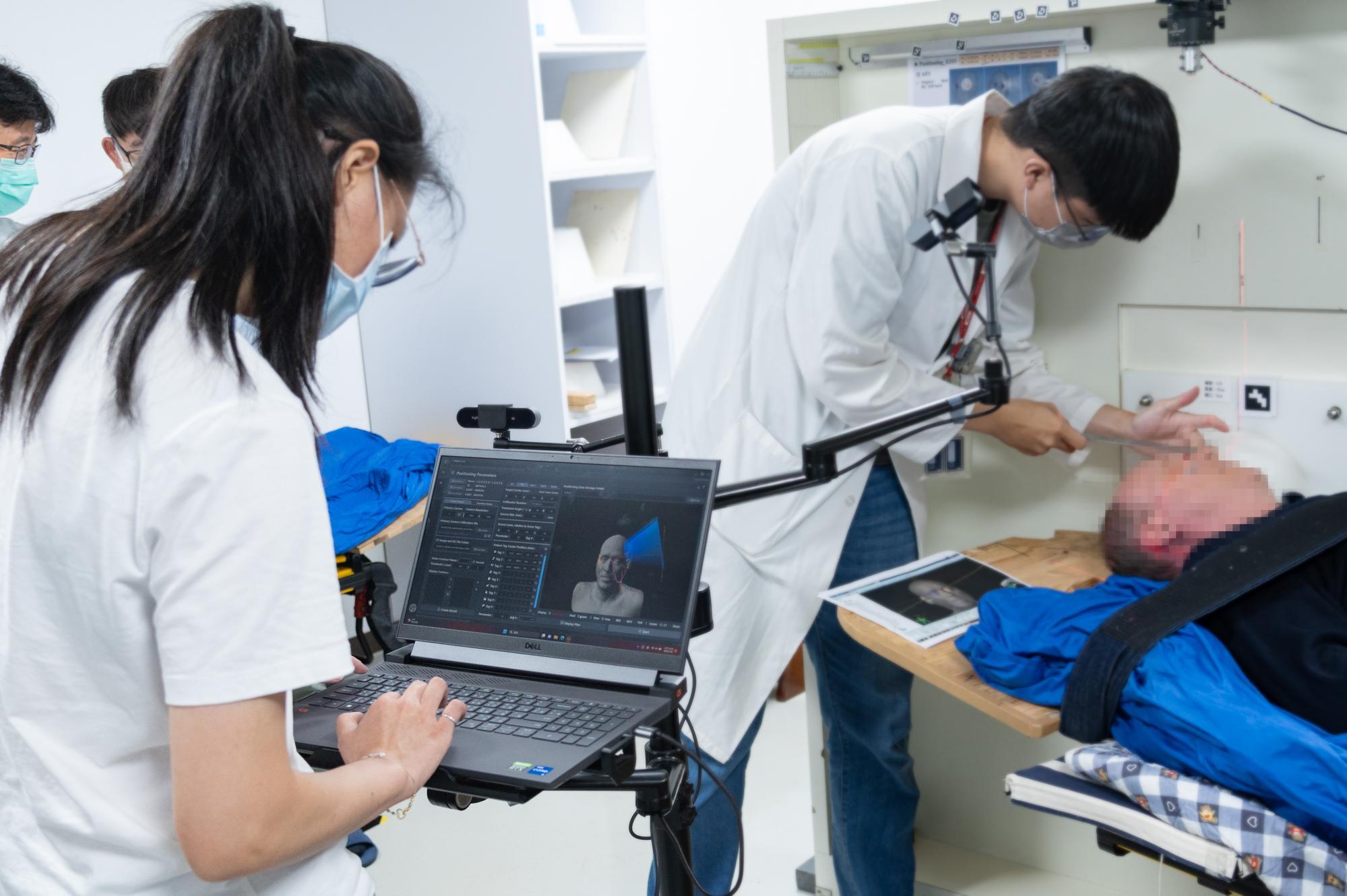 The doctor adjusting the position for the brain cancer patient to receive neutron beam irradiation.