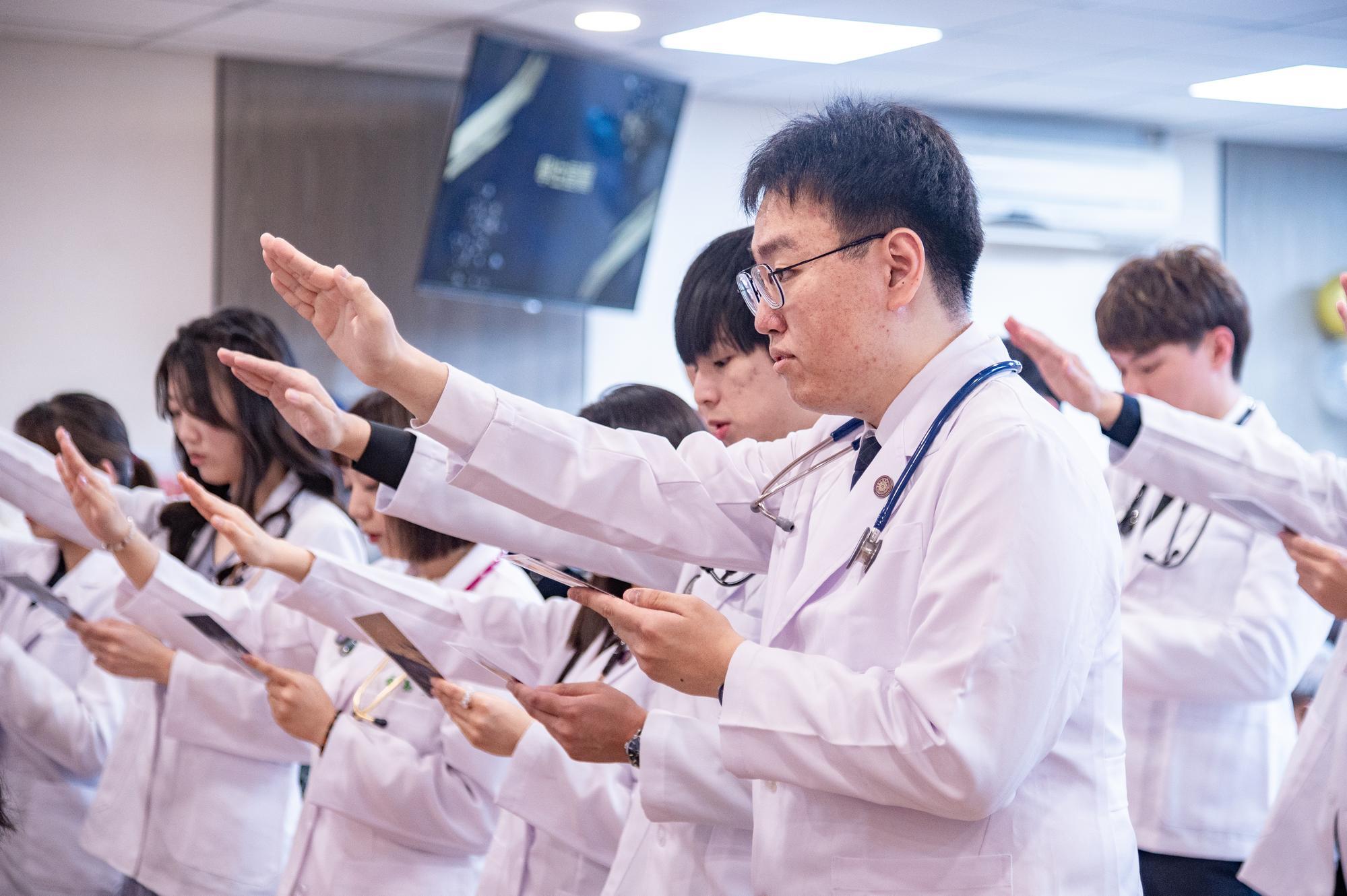 Medical students, clad in their white coats, took the oath while holding onto their initial intentions of becoming doctors.