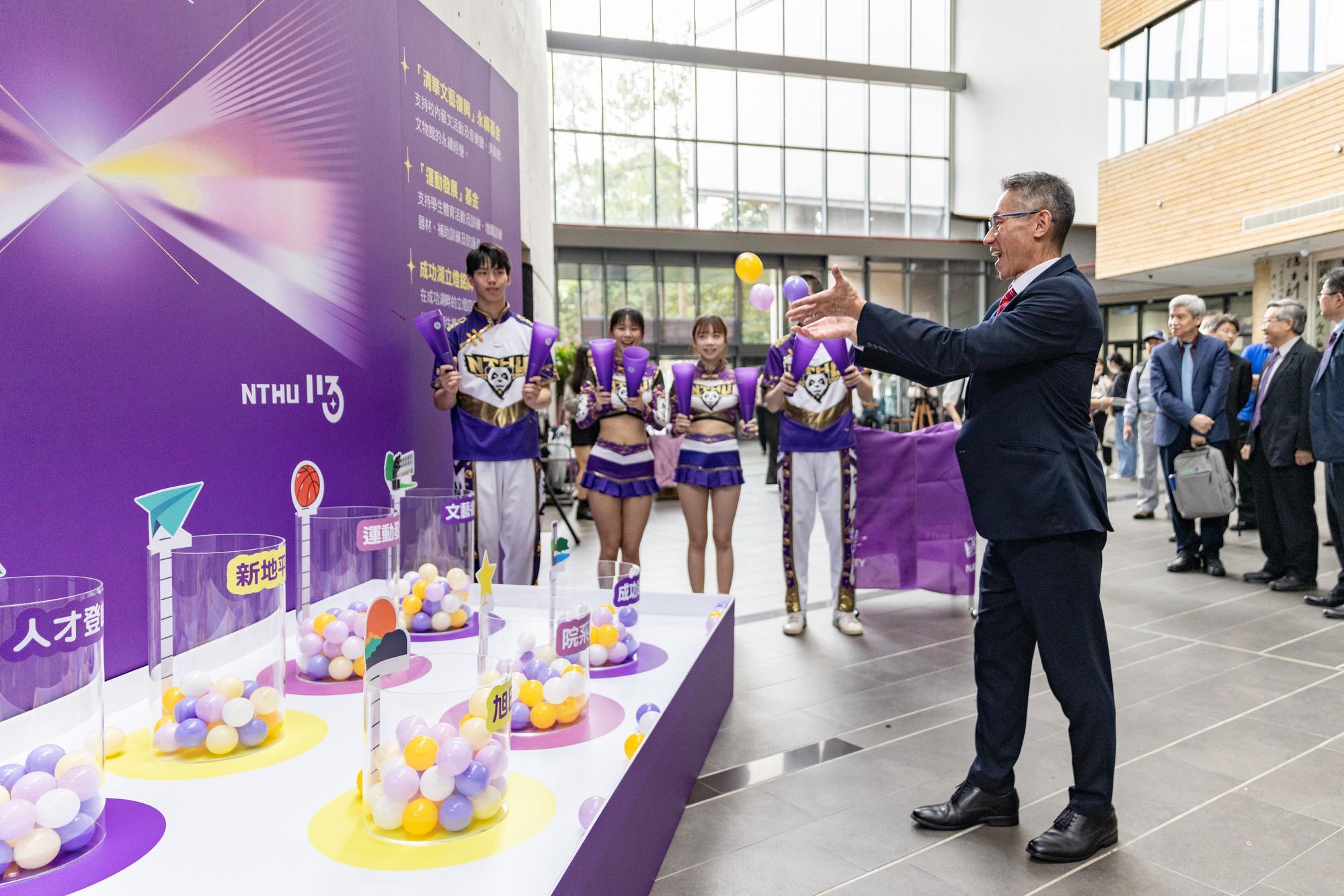 President W. John Kao (高為元) places an energy ball into the cylinder representing the Talent Fund, symbolizing the infusion of new energy into NTHU.