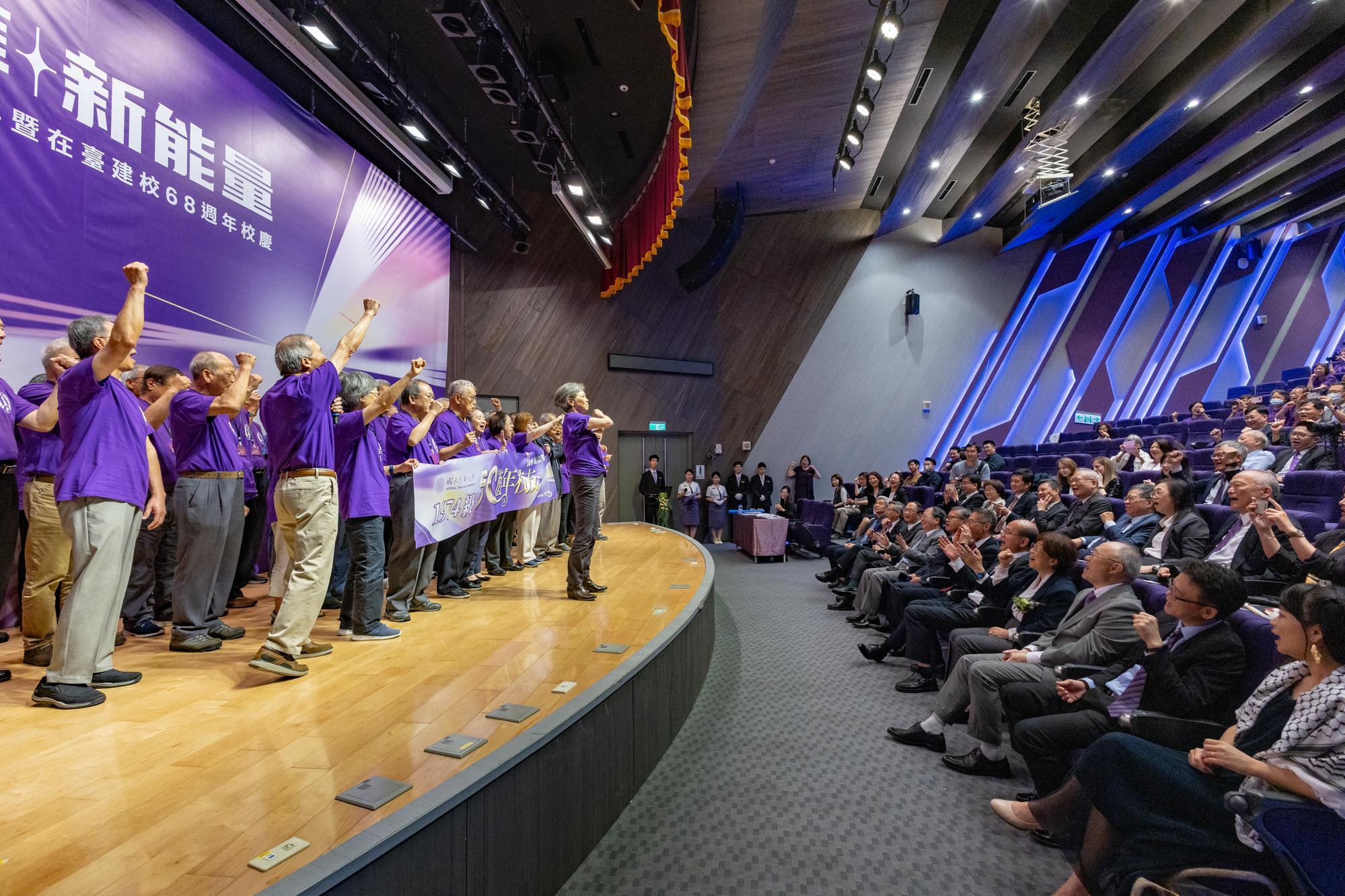 Graduates from the class of 1974 led the crowd in chanting the cheers from past Meichu sports competitions, 
