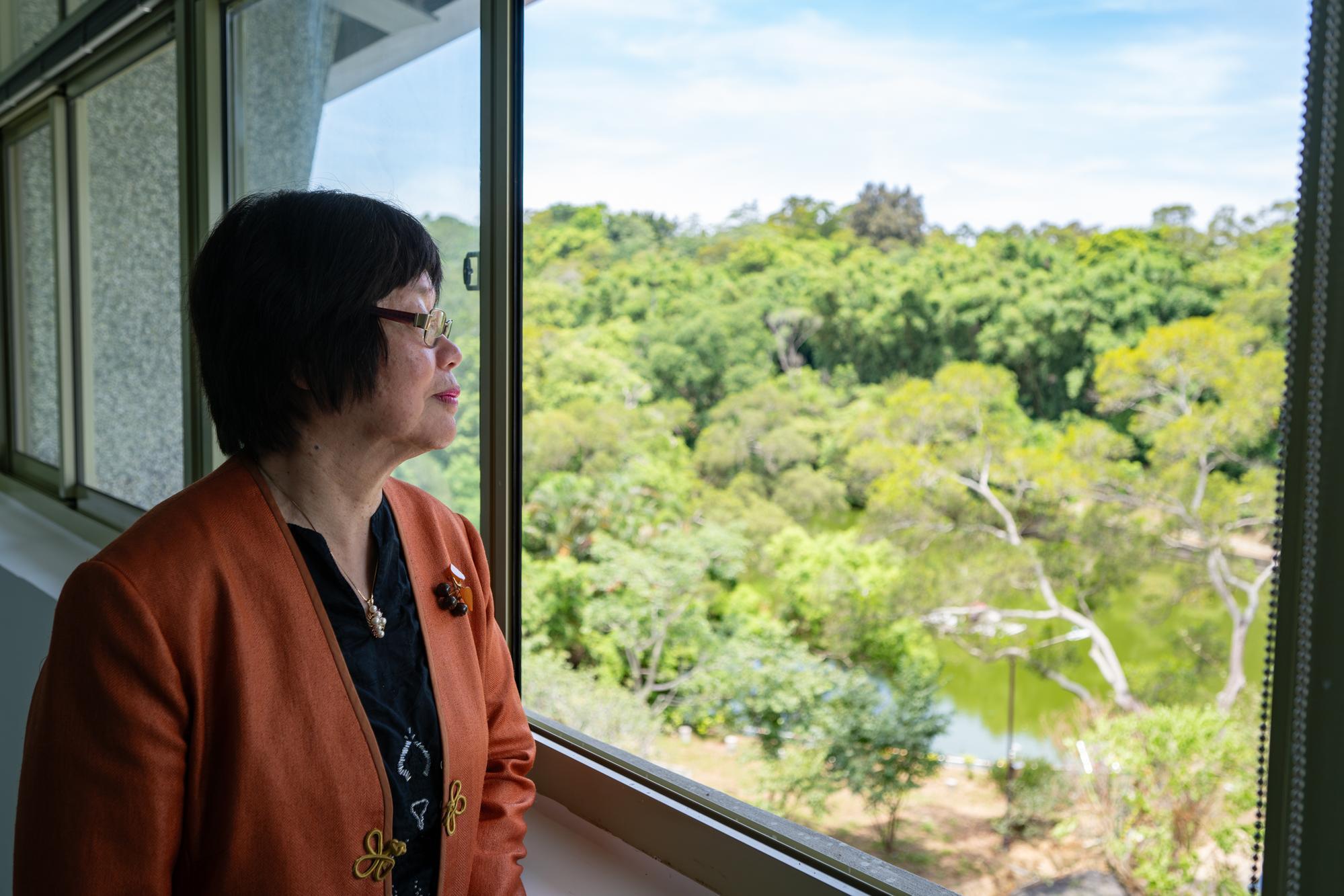 Ms. An-Yi Chou (周安儀) gazes out over Acacia Lake from the third floor of the Literature Building.