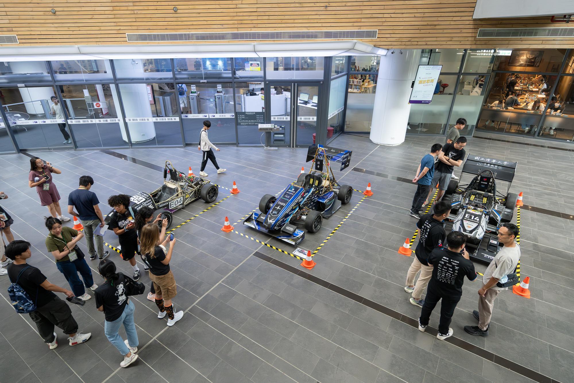 The NTHU Racing Team displays race cars from previous generations.