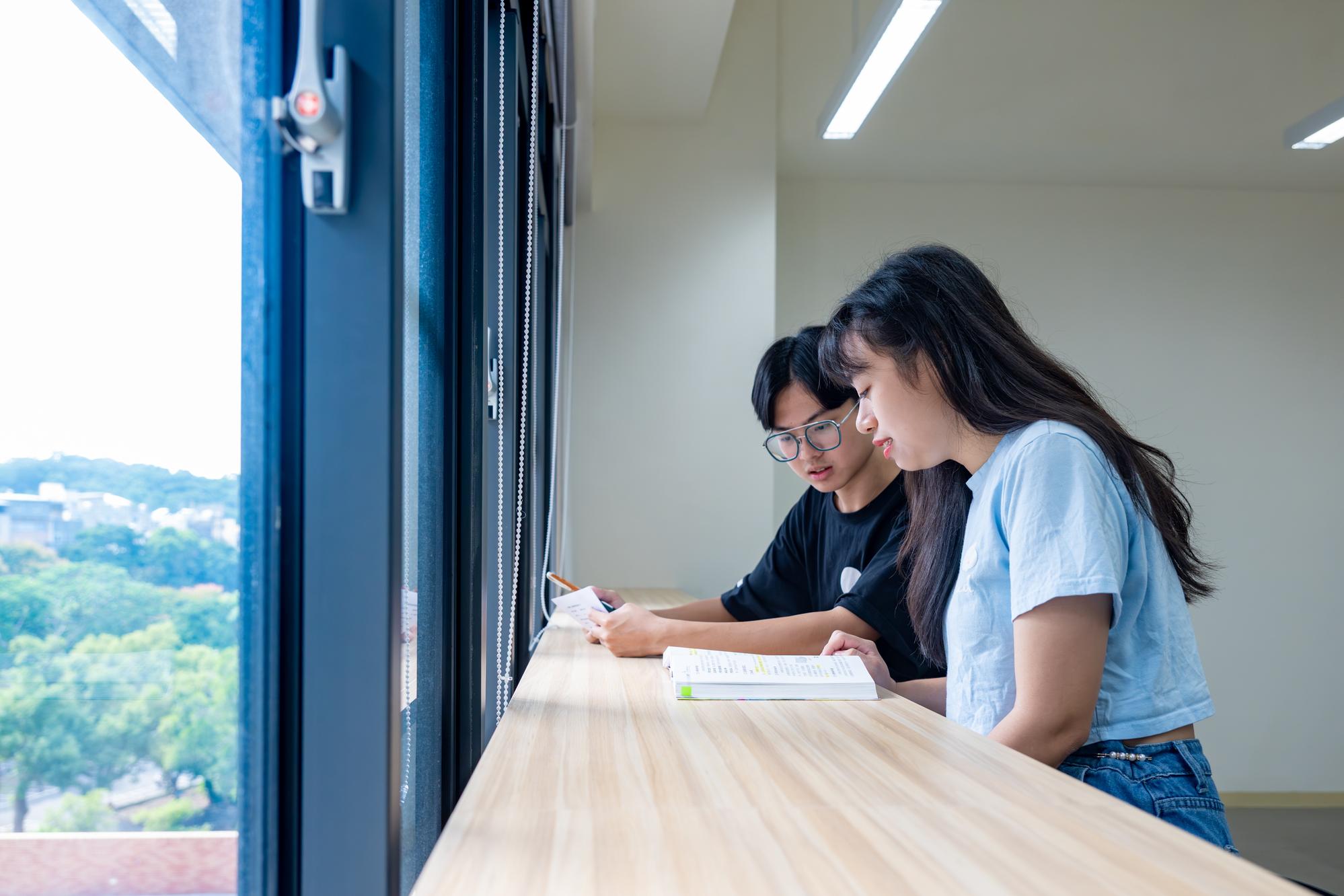 
Students discuss coursework in the open study area for graduate students inside the new College of Education building.