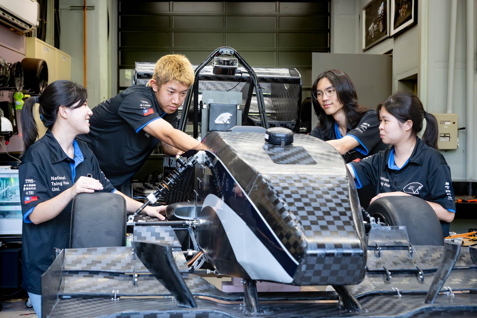 NTHU Racing Factory's 11th-generation Formula race car, TH11, features a carbon-fiber monocoque. Pictured from left are vice-captain Chih-Tsen Lo, driver and head of vehicle dynamics Hsin-Hua Yang, team captain Yi-Hsun Liao, and vice-captain Yun-Hsi Tsai.