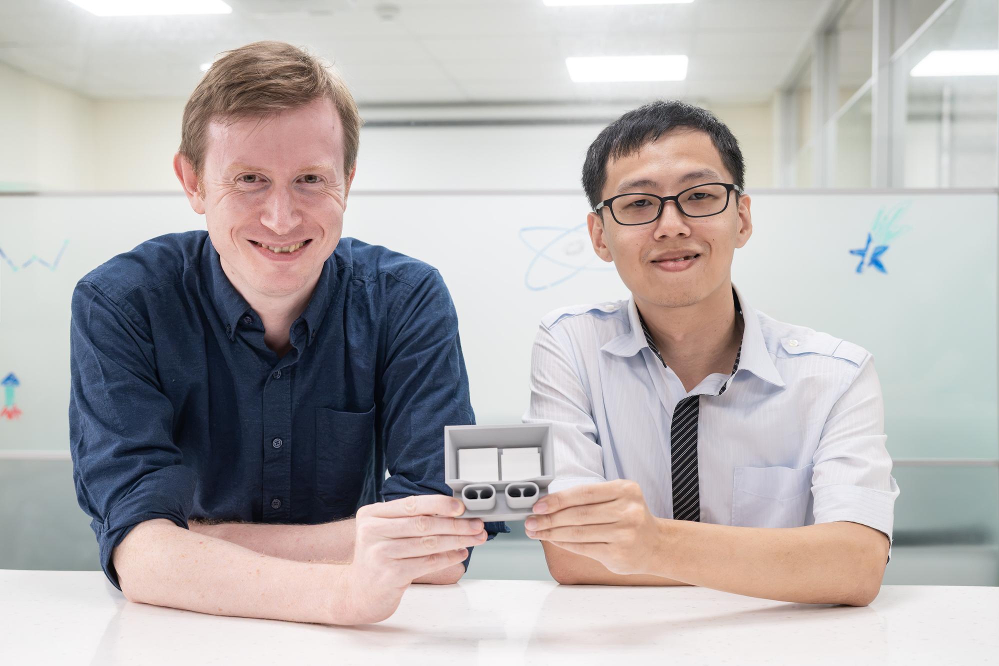 NTHU Associate Professor Andrew Cooper (right) and doctoral student Chung-Wen Wang (left) of the Institute of Astronomy present a 3D model of the mission's dual-telescope system.