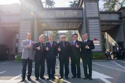 All six past and present presidents of NTHU and NHCUE have their thumbs up to celebrate the successful merge.