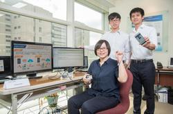
Team members Chen Peng-Tzu (front), Shao Naijun (standing on right), and Wei Shiying (standing on left) displaying their Instacardeal mobile payment system.