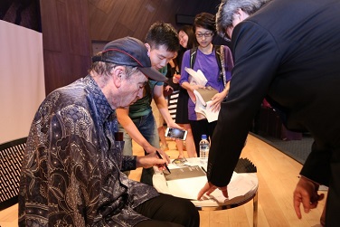 Sachs autographing copies of his books.